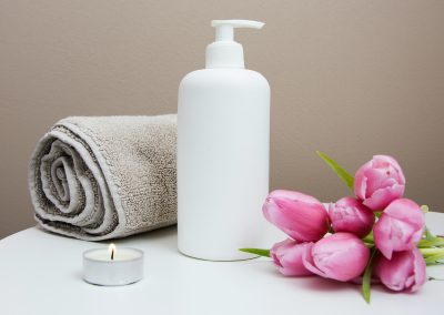 body lotion, towel and flowers - reflexology related